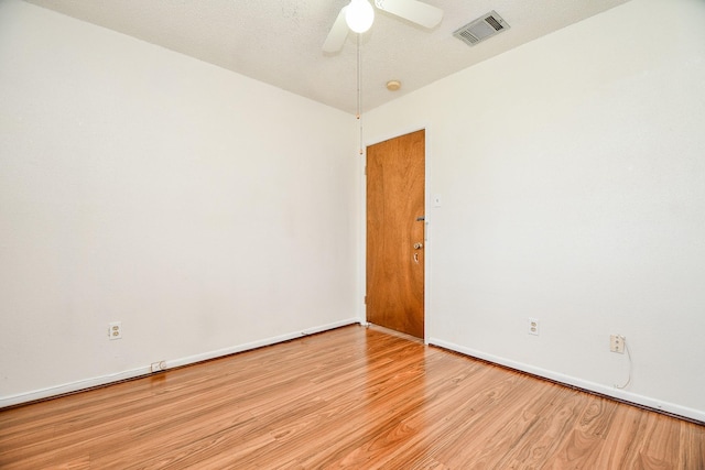 spare room with ceiling fan and light wood-type flooring