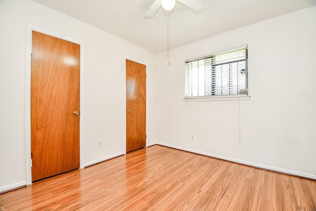 unfurnished bedroom featuring ceiling fan and light wood-type flooring