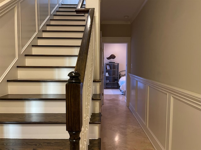 stairs featuring ornamental molding and tile patterned floors