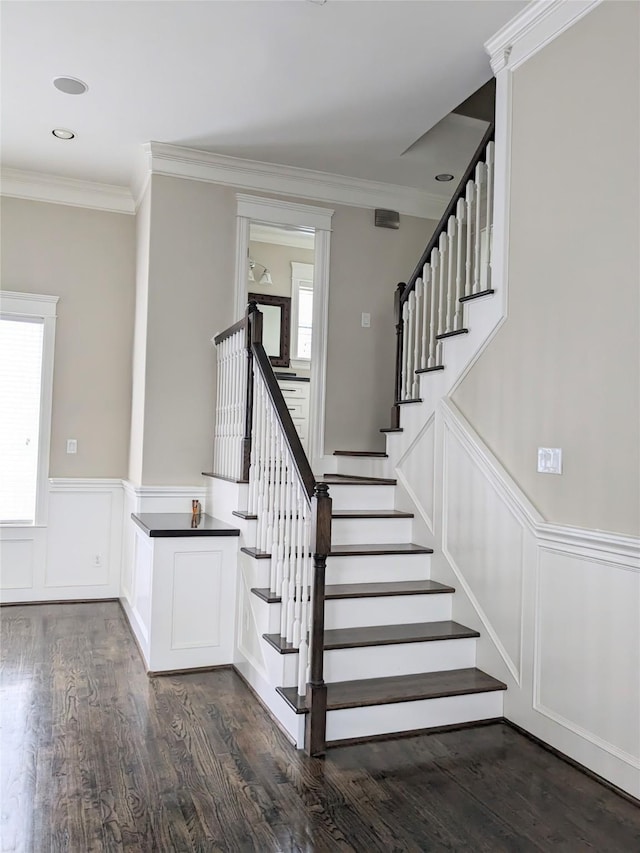 stairs featuring crown molding and wood-type flooring