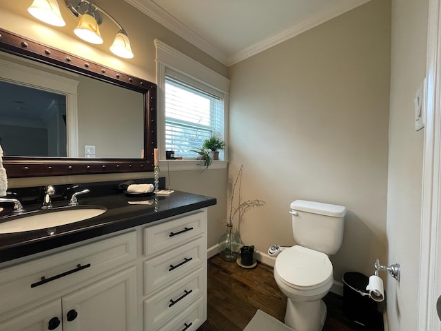 bathroom featuring hardwood / wood-style flooring, ornamental molding, toilet, and vanity