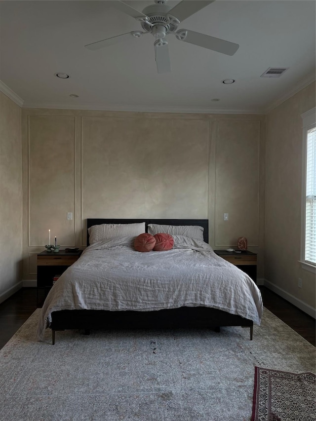 bedroom featuring dark hardwood / wood-style flooring, crown molding, and ceiling fan