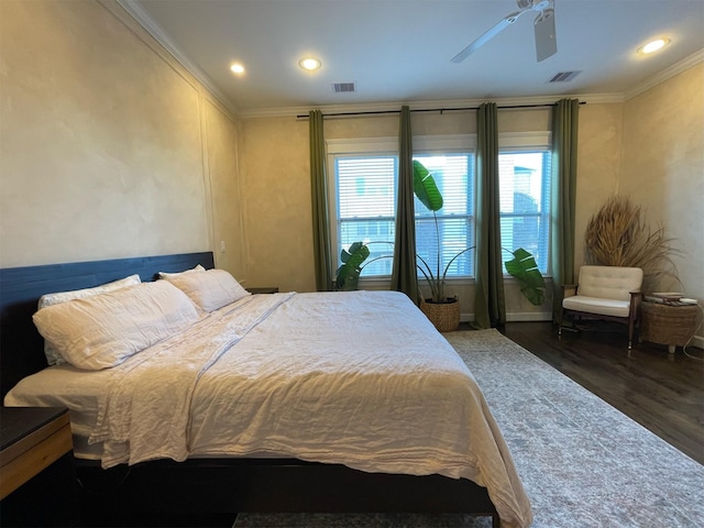 bedroom with crown molding, ceiling fan, and dark wood-type flooring