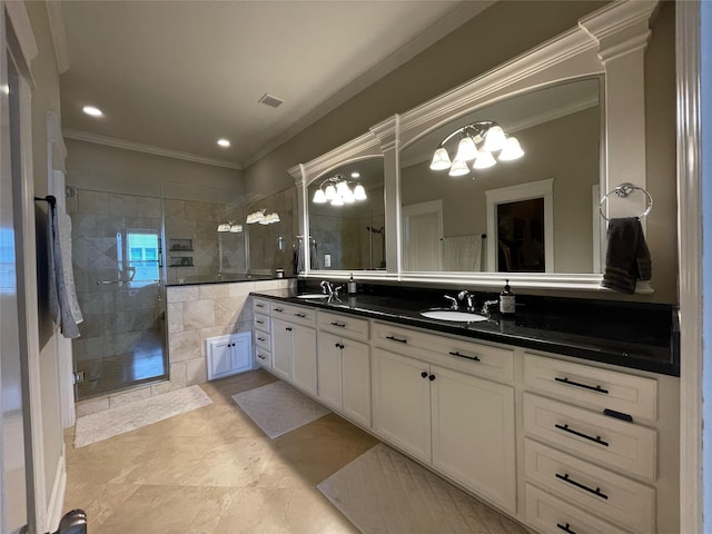 bathroom with vanity, ornamental molding, and an enclosed shower