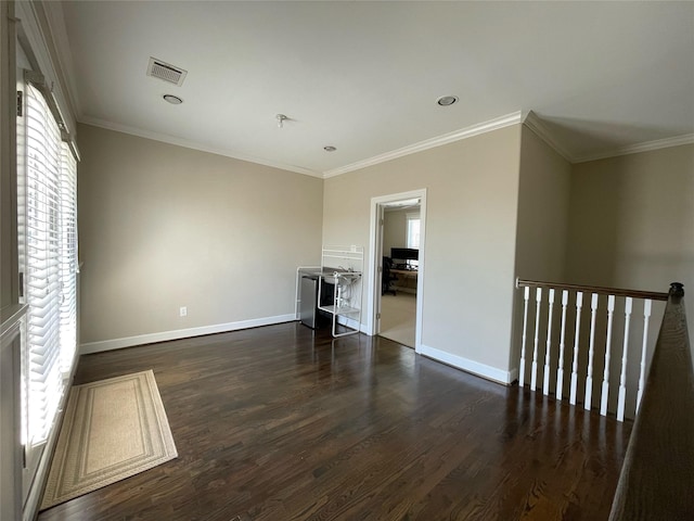 unfurnished living room featuring ornamental molding and dark hardwood / wood-style flooring