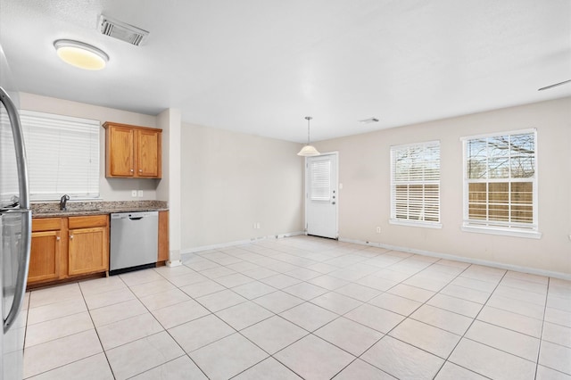 kitchen with stainless steel dishwasher, visible vents, hanging light fixtures, a sink, and light stone countertops