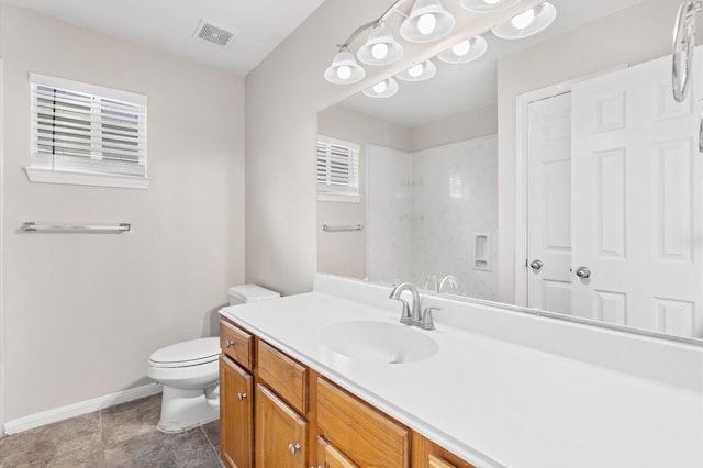 bathroom featuring vanity, baseboards, visible vents, toilet, and tile patterned floors