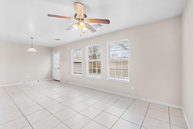 empty room featuring baseboards, visible vents, and ceiling fan