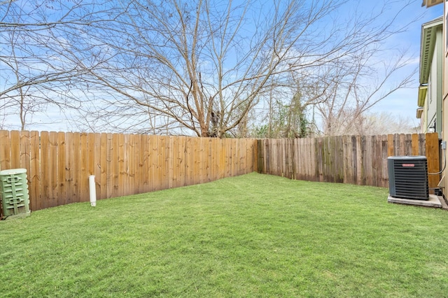 view of yard featuring central air condition unit and a fenced backyard