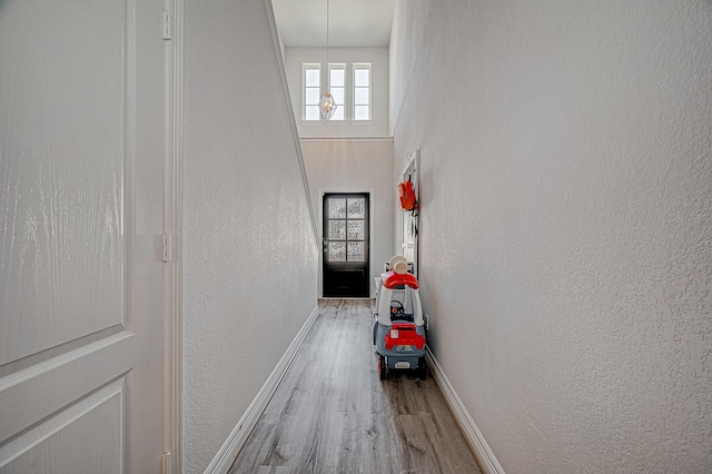 interior space with a towering ceiling and light wood-type flooring