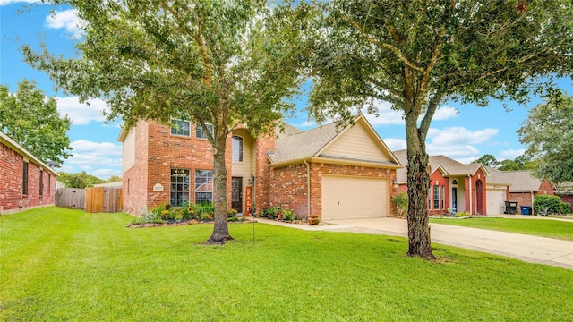 traditional-style house featuring brick siding, an attached garage, a front yard, fence, and driveway