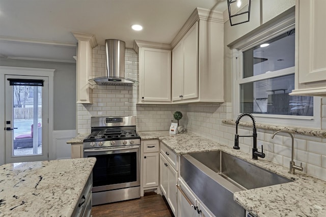 kitchen with sink, dark hardwood / wood-style floors, light stone counters, gas stove, and wall chimney exhaust hood