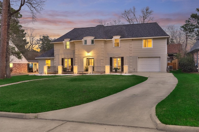 view of front of property featuring a garage and a lawn