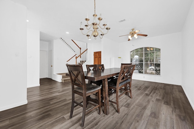 dining room featuring stairs, dark wood-style floors, visible vents, and baseboards