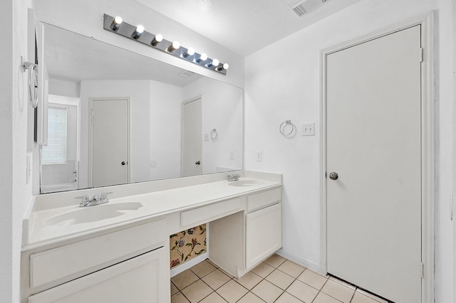 bathroom with double vanity, tile patterned flooring, visible vents, and a sink