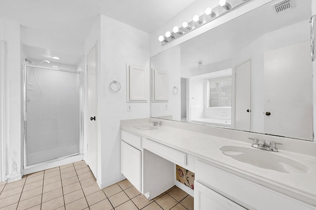 bathroom featuring a stall shower, tile patterned flooring, visible vents, and a sink