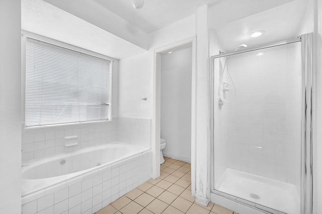 full bathroom with tile patterned flooring, a shower stall, and toilet