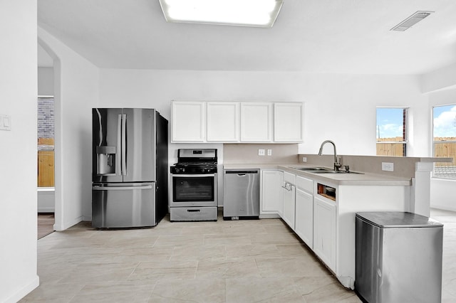 kitchen with visible vents, white cabinets, appliances with stainless steel finishes, light countertops, and a sink