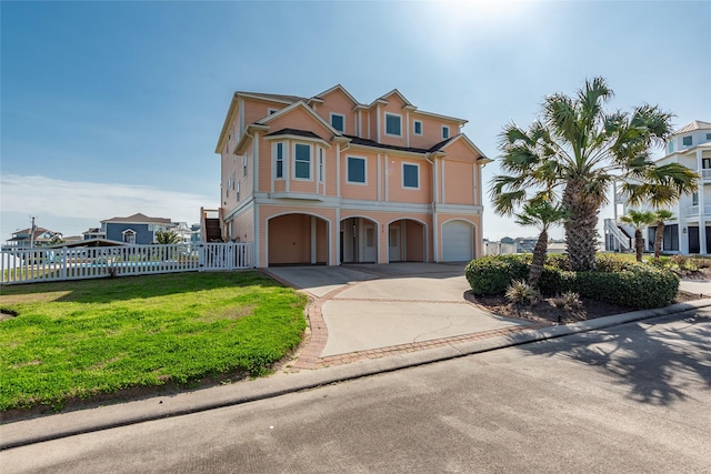 view of front of property featuring a garage and a front yard