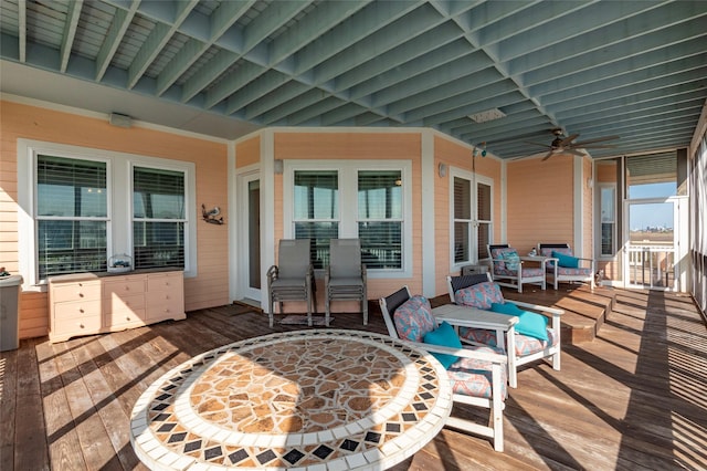 wooden deck with ceiling fan and an outdoor living space