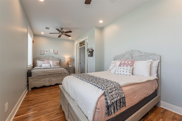 bedroom with ceiling fan and hardwood / wood-style floors