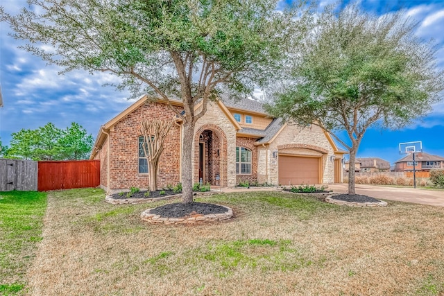 view of front of home with a garage and a front lawn