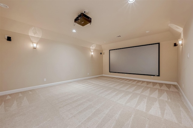 cinema room featuring light carpet