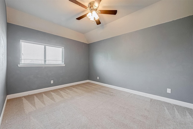 carpeted empty room with ceiling fan and lofted ceiling