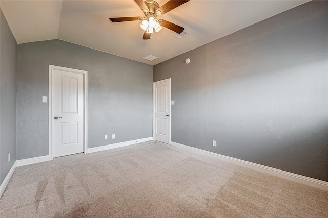 carpeted spare room featuring ceiling fan and lofted ceiling