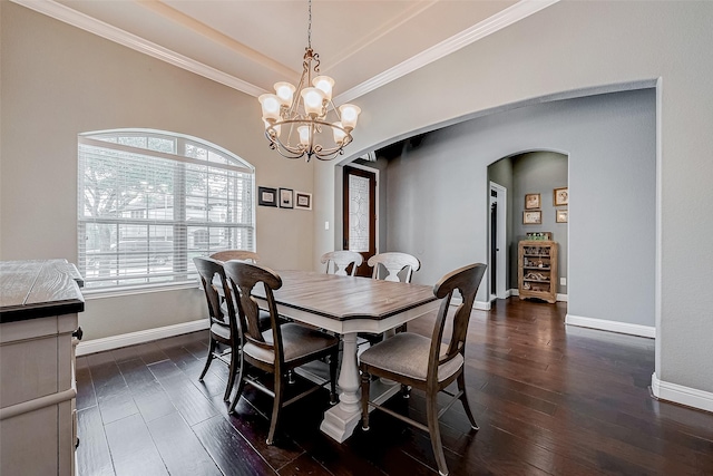 dining room featuring crown molding, dark hardwood / wood-style floors, and a chandelier