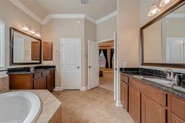 bathroom featuring tile patterned flooring, crown molding, tiled bath, and vanity