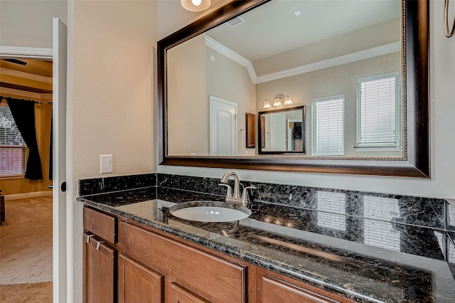 bathroom featuring ornamental molding and vanity