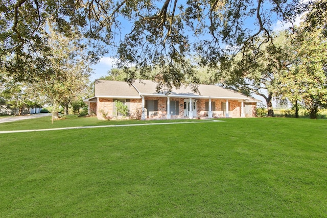 ranch-style home featuring a porch and a front yard