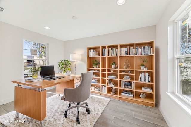 office space with recessed lighting, wood tiled floor, visible vents, and baseboards