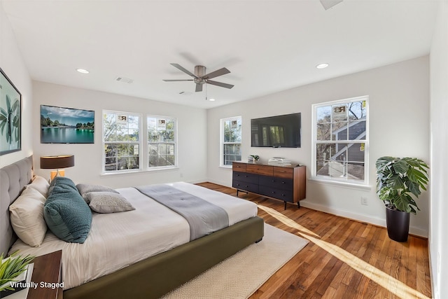 bedroom featuring recessed lighting, visible vents, baseboards, and wood finished floors