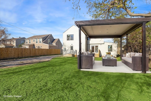 back of property with a yard, a patio area, fence, and an outdoor living space