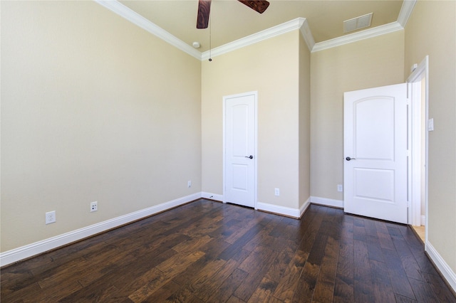 unfurnished bedroom featuring a towering ceiling, ornamental molding, dark hardwood / wood-style floors, and ceiling fan