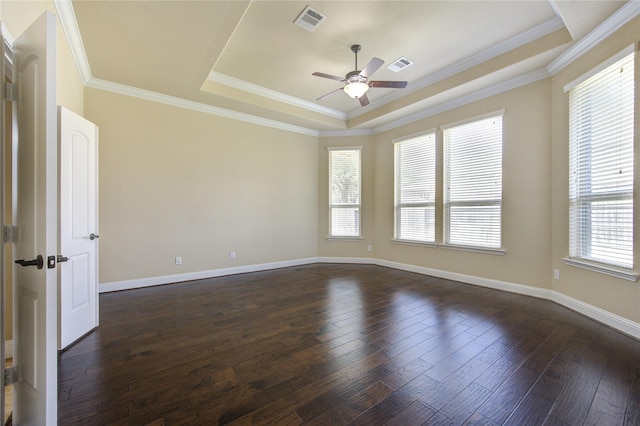 empty room with dark hardwood / wood-style flooring, ornamental molding, a raised ceiling, and ceiling fan