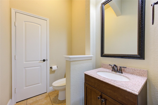 bathroom featuring tile patterned flooring, vanity, and toilet