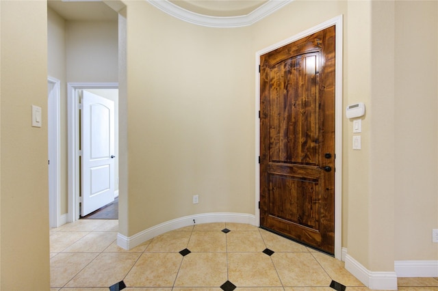 entryway featuring crown molding and light tile patterned flooring