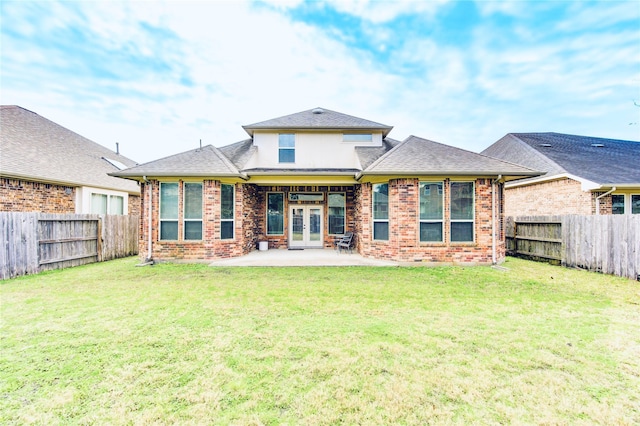 back of house with french doors, a yard, and a patio area