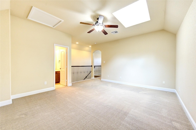 carpeted empty room featuring vaulted ceiling and ceiling fan