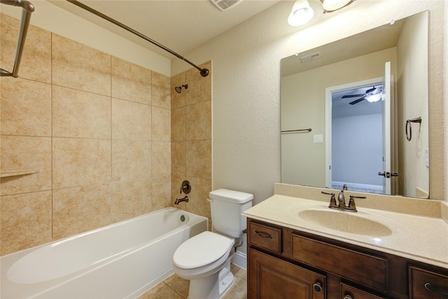 full bathroom featuring vanity, toilet, tiled shower / bath combo, and tile patterned flooring