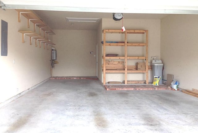 garage with a garage door opener and electric panel