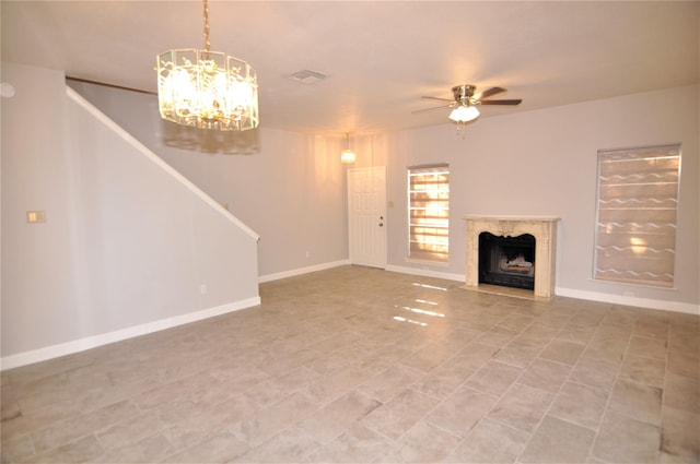 unfurnished living room with ceiling fan and a high end fireplace