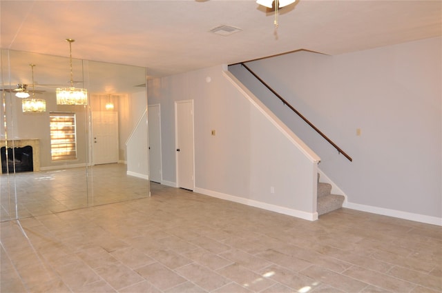 interior space featuring ceiling fan with notable chandelier