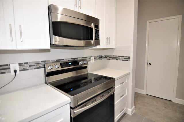 kitchen with white cabinetry, tasteful backsplash, and stainless steel appliances