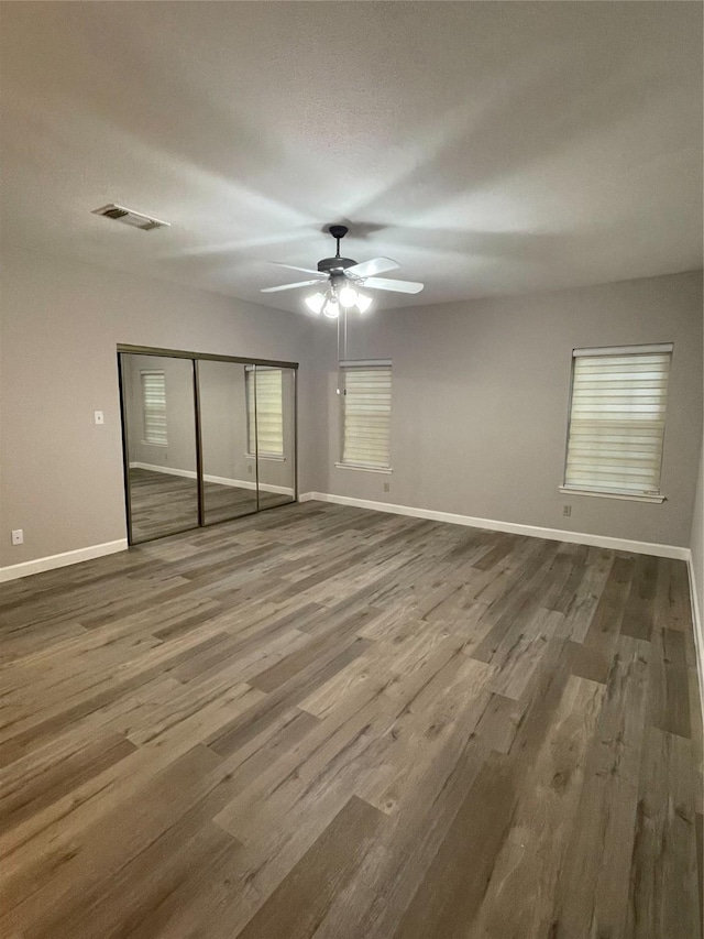 unfurnished room with hardwood / wood-style flooring, a textured ceiling, and ceiling fan