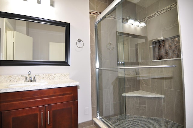 bathroom featuring vanity and a shower with shower door