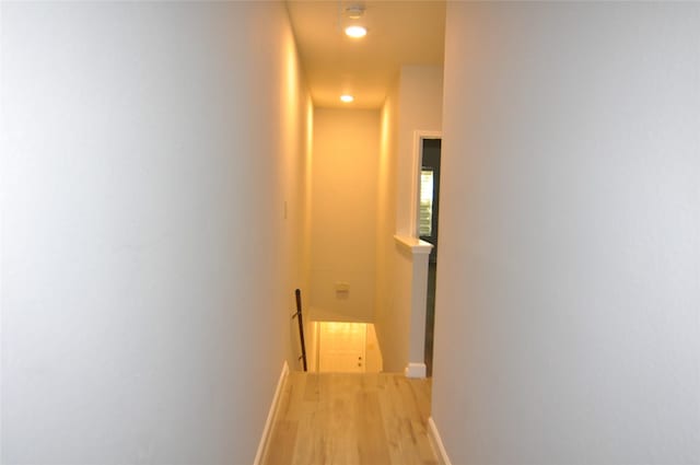 corridor with hardwood / wood-style floors